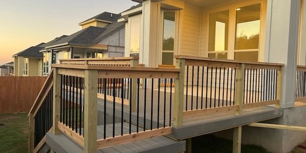 Custom composite deck with wood railing and metal balusters.  