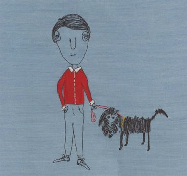 Embroidered man in red sweater walking a dog.