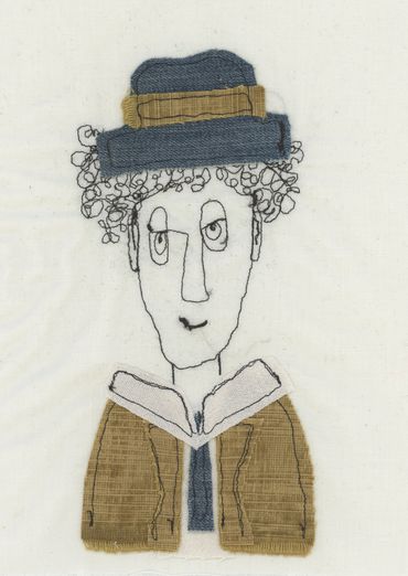 textile art of man in a suit wearing a hat 