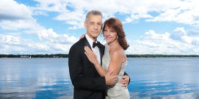 Elegant couple posing by the water on a bright day.