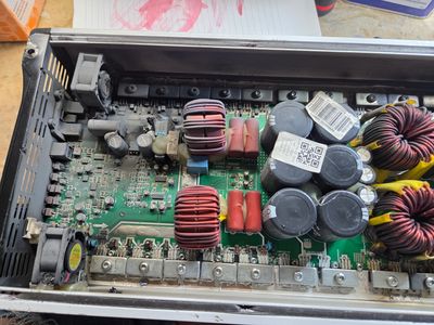 Close-up of an electronic circuit board inside a metal casing.