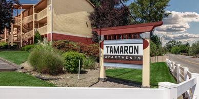 Entrance sign for Tamaron Apartments with a beige building and greenery.  Lynnwood WA