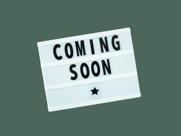 Lightbox sign displaying 'COMING SOON' with a star below.