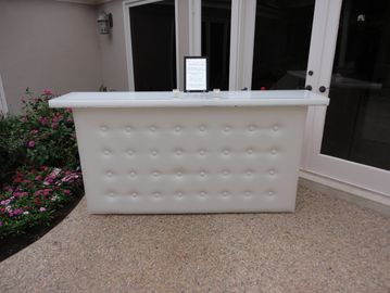 White serving bar in a patio used for a birthday party.