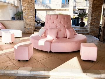 light pink tufted bench and ottomans