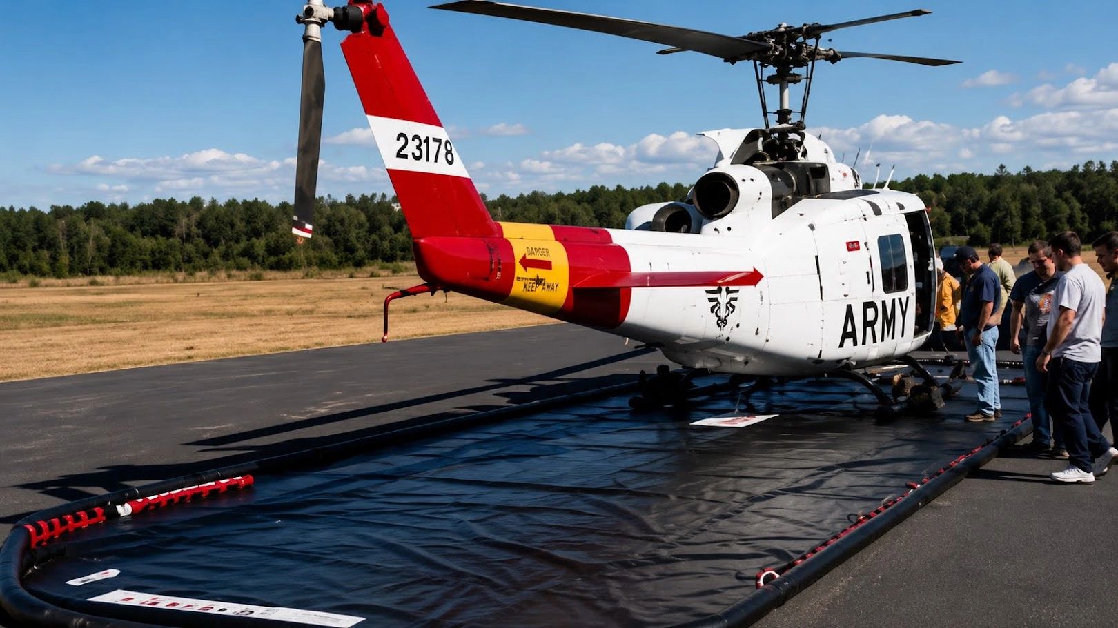 U.S. Army helicopter positioned on a portable LATIMAT wash water containment system.