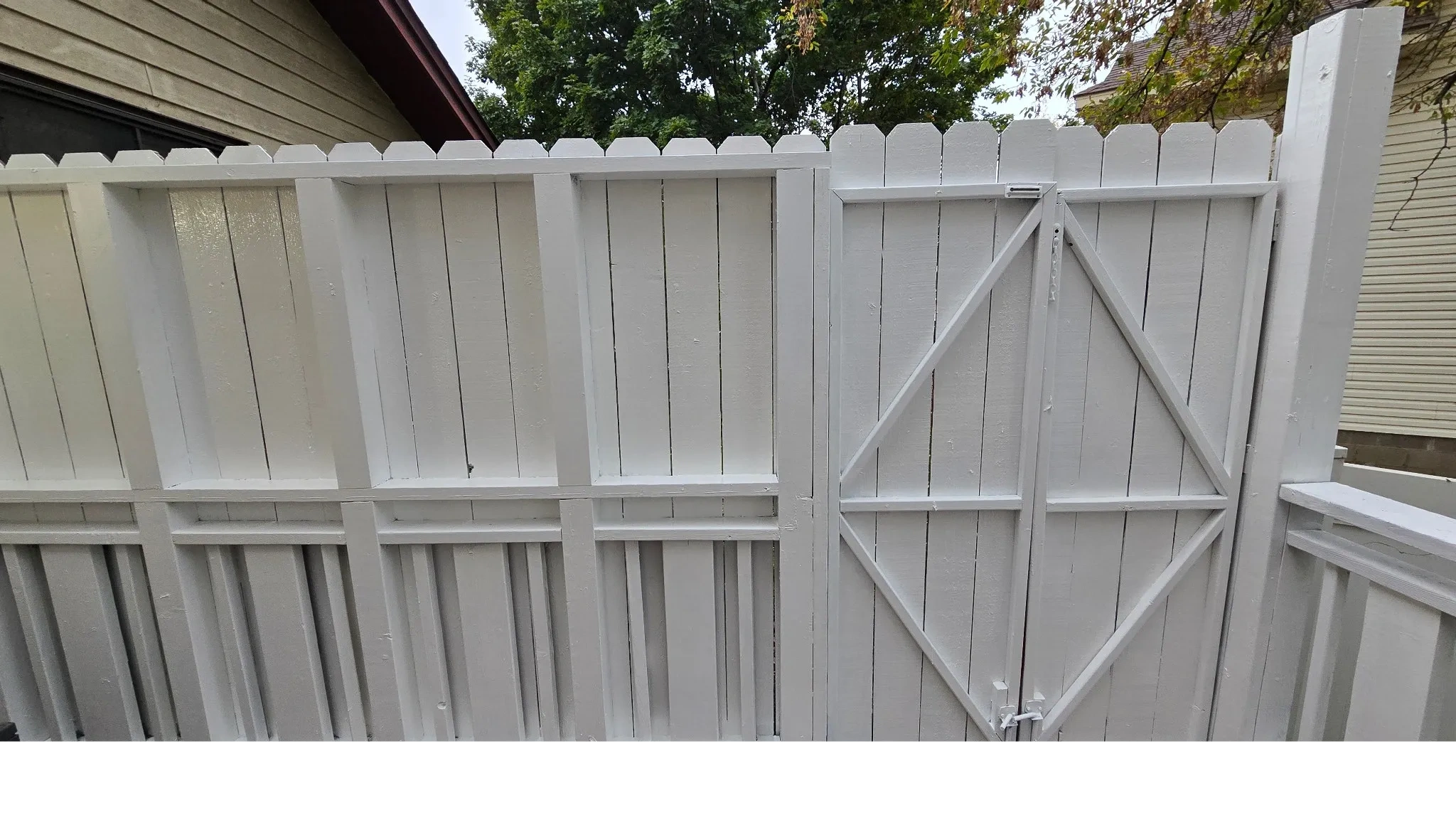 White painted wooden fence and gate — Bona Fide Services fence painting project.