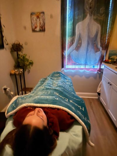 Woman resting comfortably on reiki table