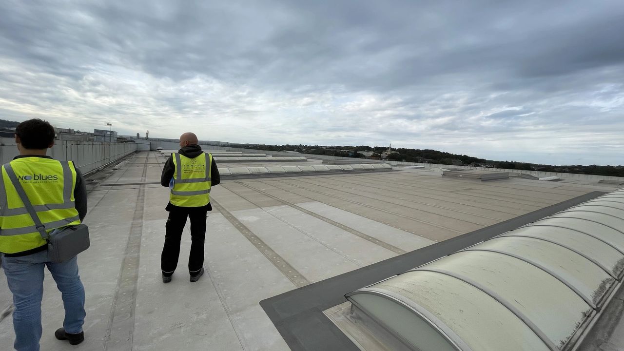 Installers standing on roof Installers standing on roof
