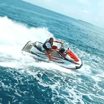 A person having fun using the jetski at the beach.