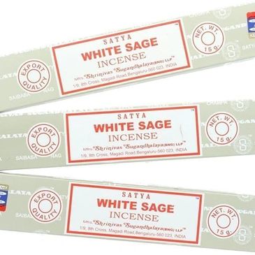 Incense sticks with holder on table, used for cleansing, calm, meditation and spiritual reflection.