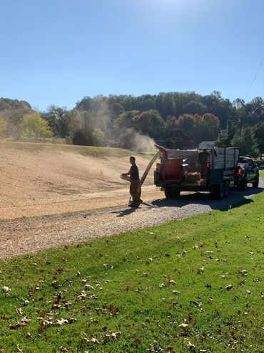 Grass seeding, grading waterway, and covering with straw