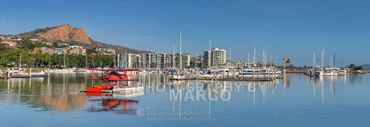 The Red Barron biplane scenic flights Townsville Yacht Club port and Castle Hill in the background.