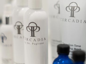 Close-up of Circadia skincare bottles by Dr. Pugliese in white with clear branding.