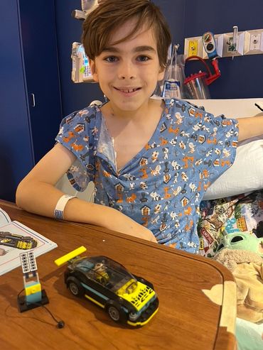 Mason with his electric car LEGO set.