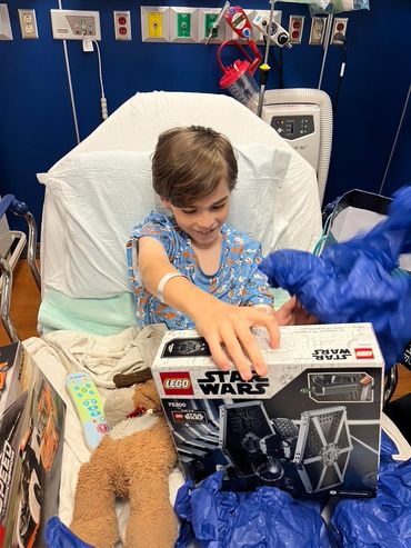 Mason smiling looking at a Star Wars LEGO box.