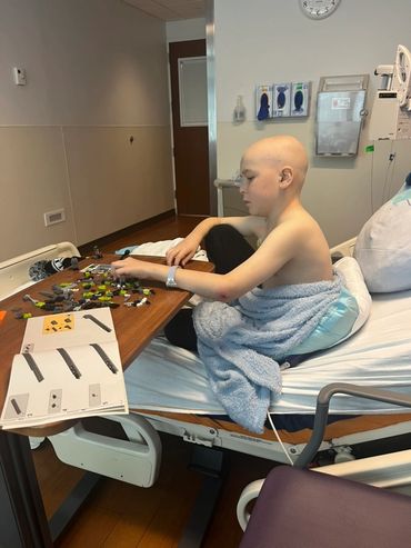 Mason building LEGOs at the hospital.