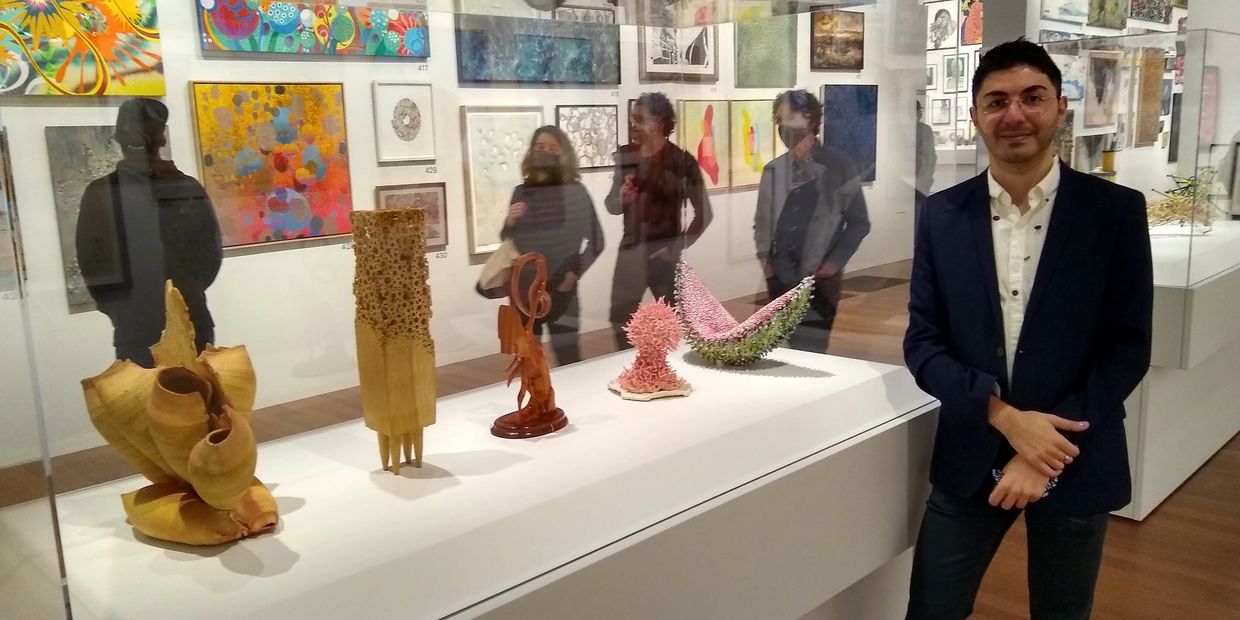 me standing next to my ceramic coral-looking sculpture in museum gallery at the deyoung museum in sf