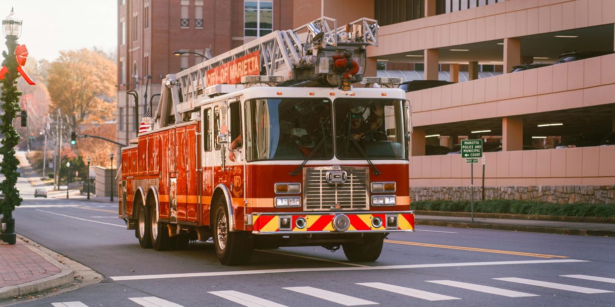 A fire truck from the City of Marietta driving on a city street.