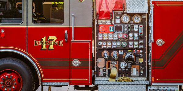 Close-up of a fire truck's control panel and side door with Engine 17 label.