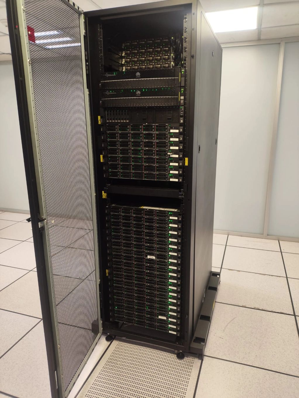 Open server rack with multiple active servers inside a data center.