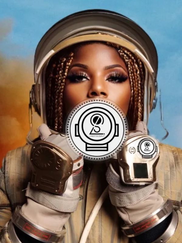 Woman astronaut with braided hair in space suit.