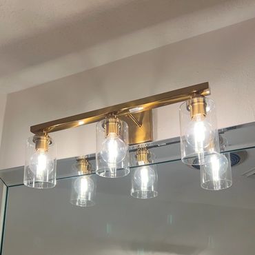 gold light fixture in bathroom installed by Wired Electrical Services technician