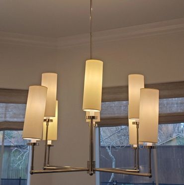 light fixture installation in dining room with a warm light