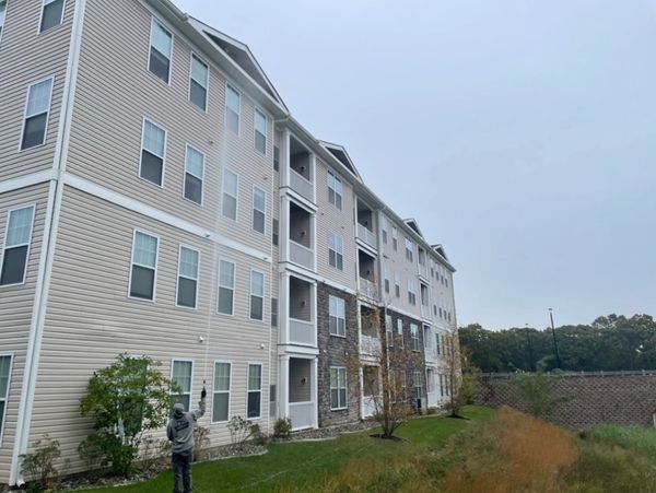 Pressure washing a four story condo with our cleaning solution to get it looking brand new.         