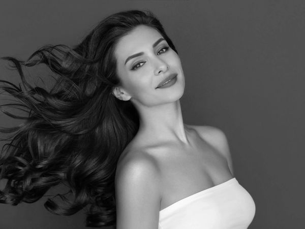 Headshot of a beautiful girl with windswept hair. 