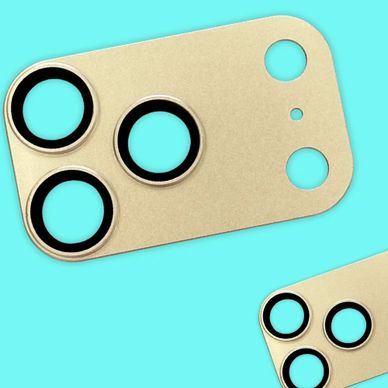 Gold camera lens covers on a turquoise background.