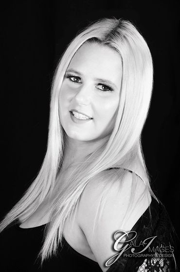 Black and white portrait of a smiling woman with long blonde hair.