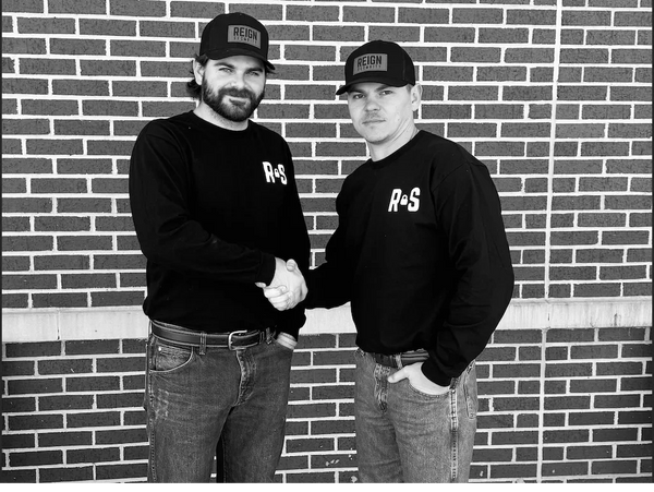 Owners Hank Daily and Chance Goff shaking hands. Wearing Reign Security merch
