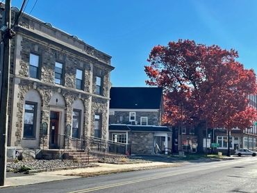 A street with some buildings and trees on the side