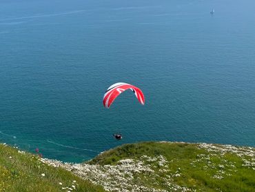 Drone following a parasail over Dorset