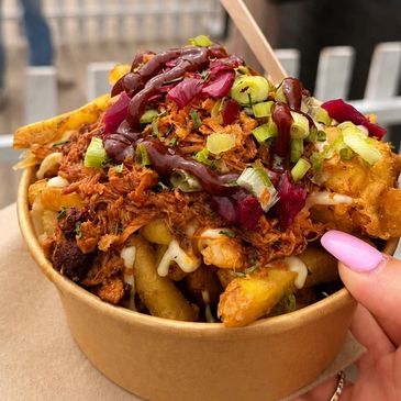 Loaded fries with pulled meat and sauces.