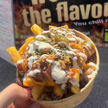Loaded fries with sauce, jalapeños, and chicken.