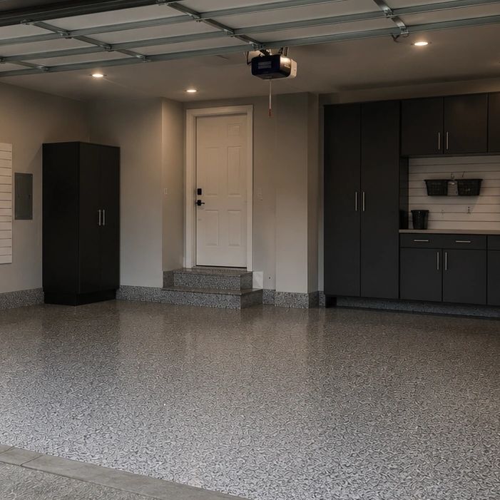 Clean, organized garage with dark cabinets and epoxy flooring.