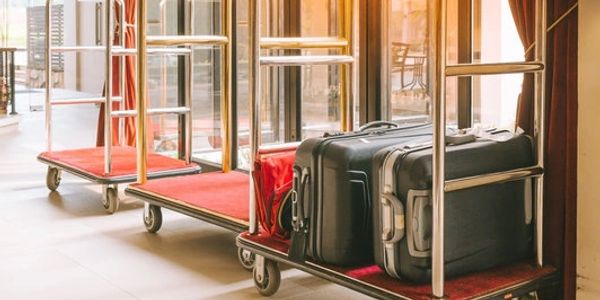 Hotel luggage carts with suitcases.