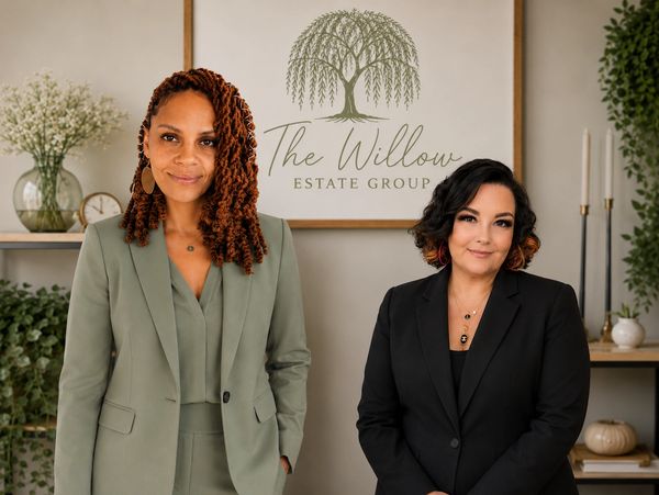 Two women standing in front of a The Willow Estate Group sign.