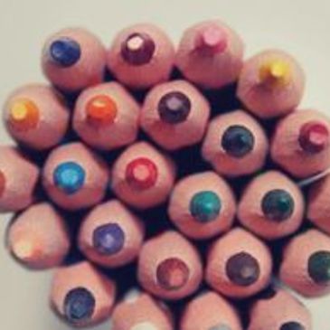 Close-up of colored pencil tips arranged together.