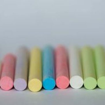 Assorted pastel-colored chalk pieces lined up.