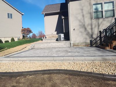 Landscape design, patio outdoor, brick laying. Pictured is Brussel block/Basalt border/920 Slate