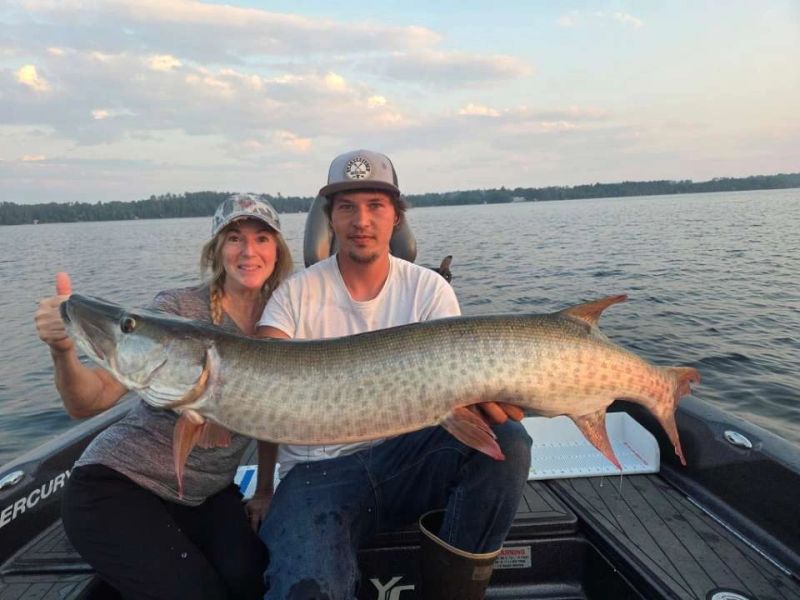 Two anglers holding a giant tiger muskie caught near Ely, Minnesota