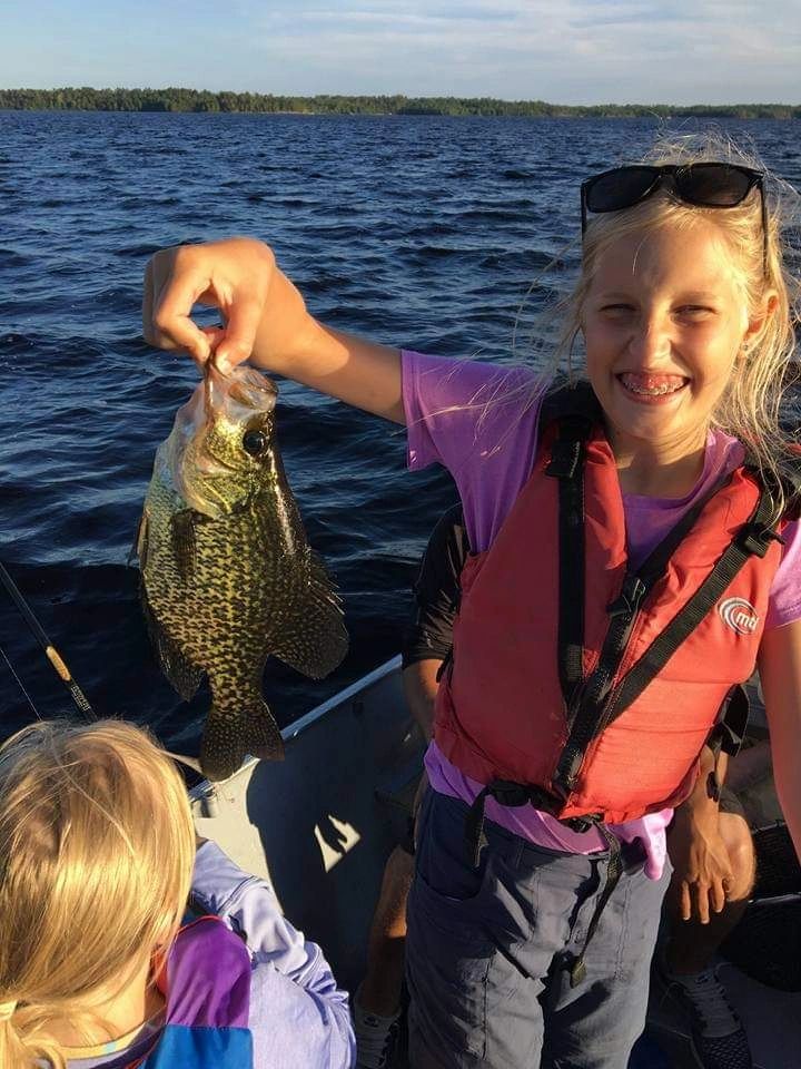 Young angler holding a crappie