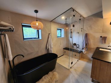 4 Piece bathroom, with a custom steam shower, large black soaker tub, and teak vanity, in Kitchener 