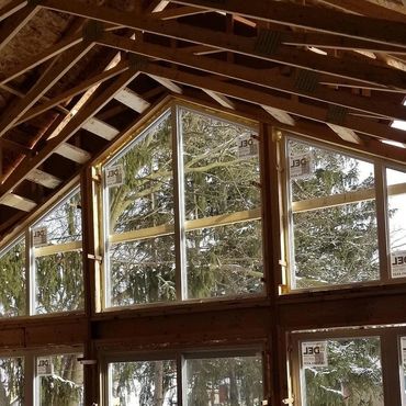 Custom addition being framed with a cathedral ceiling and full wall of windows in Galt, Cambridge 