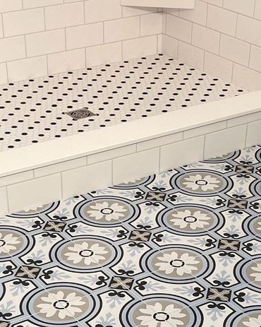 Patterned tile on a bathroom floor, looking into the custom tiled shower. 