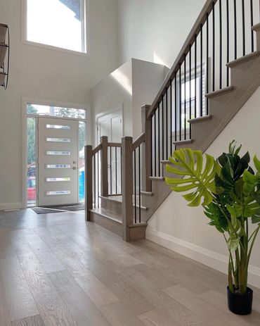 Front foyer with beautiful oak staircase and railings with black iron spindles, Lots of windows