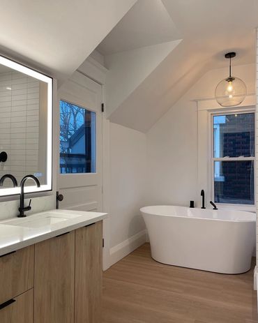 Beautiful 4 piece washroom with freestanding tub, and white oak vanity. Lighted led mirror